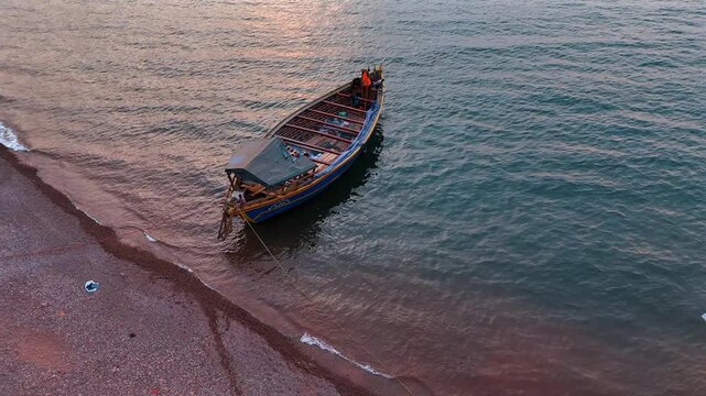Fisherman on a wooden dhow in Lake Tanganyika, capturing traditional fishing and lakeside life in Tanzania.