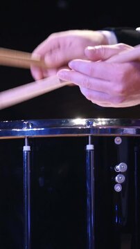 Drum performer plays drumstick at the stage