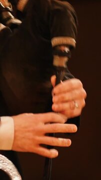 Bagpipe player plays musical instrument at the stage