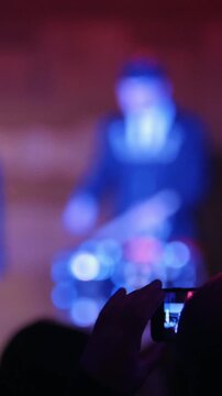 Spectators at concert - people shooting performance on smartphone, scottish musicians