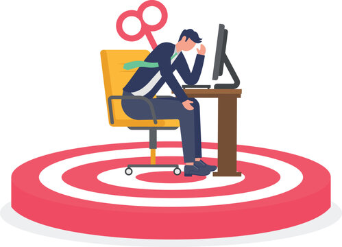 Tired employee with wind up key on target board