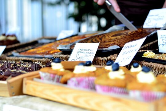 Vegan market stall selling baked goods and muffins.