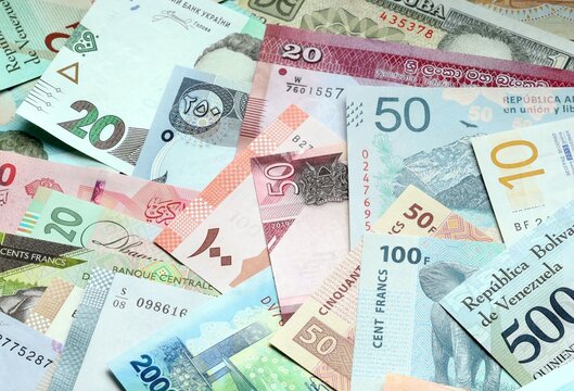 Big amount of money bills of various currencies. Assortment background of international cash