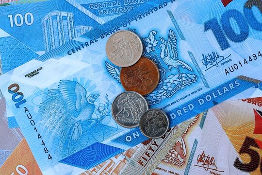 Trinidad and Tobago dollar money bills and coins on table. Trinidad and Tobago cash of TTD currency