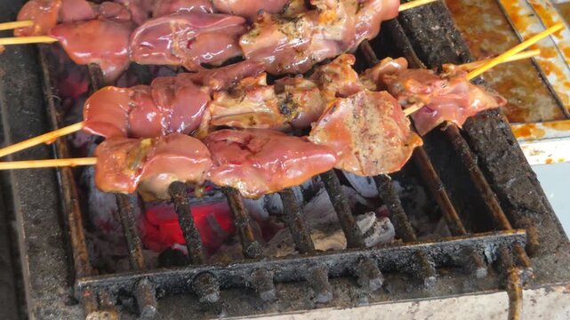 Thai Style Grilled Chicken Liver Skewers Cooking on a Charcoal Grill