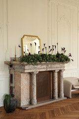Obraz premium Elegant Room Interior with Fireplace Decorated with Dark Calla Lilies, Greenery and Gold Mirror