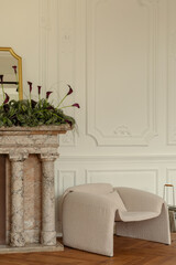 Obraz premium Elegant Interior Scene with Modern Furniture and Floral Arrangement by Fireplace in a Bright Room