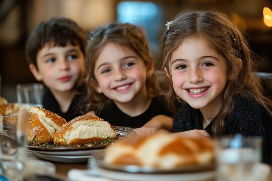 three children seated at a table with braided loaves on plates in a warm cozy setting expressing eager anticipation