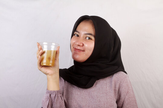 young woman with glass of kolak pisang