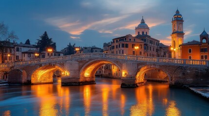 Obraz premium stone arched bridge over calm canal at twilight with golden reflections and historic domed buildings and bell tower, serene evening atmosphere