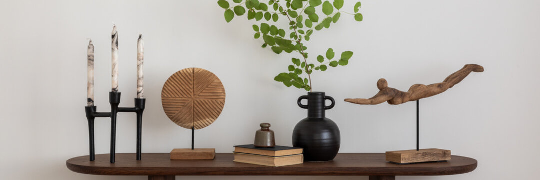 Stylish and minimalist composition on wooden design commode with copy space, flowers in vase, decorations and personal accessories. Template.