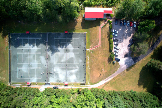 Top Down Aerial Drone View of Clay Court Tennis Club with Players and Long Shadows, Rural Virginia