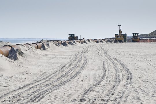 Sand flushing on the beach, Langeoog, Lower Saxony, Germany