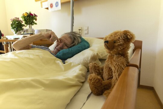 Senior citizen with dementia lying in her room in a retirement home, portrait, Baden-W&uuml;rttemberg, Germany