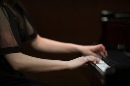 Hands and arms of a young pianist playing on the keyboard of a Steinway & Sons grand piano, Stuttgart, Baden-W&uuml;rttemberg