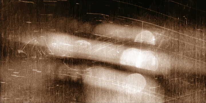 A cold winter storm creates an abstract wet texture of rain drops on a car window with a dark grunge pattern