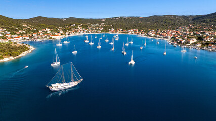 achts anchored in Vinišće bay with coastal village and Adriatic shoreline, Croatia © Tomasz