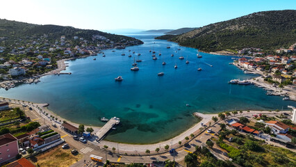 Bay view toward open sea with anchored yachts and coastal cliffs © Tomasz