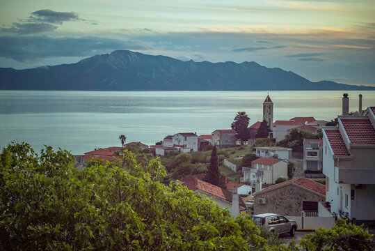 Gradac, Croatia: Coastal village with church tower and mountains