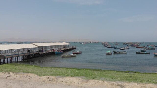 Aerial view of Paracas Bay with tourist boats and pier, Ica, Peru.