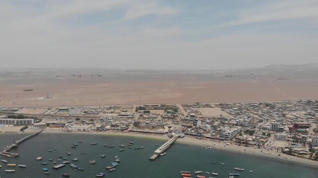 Aerial view of Paracas Bay with tourist boats and pier, Ica, Peru.