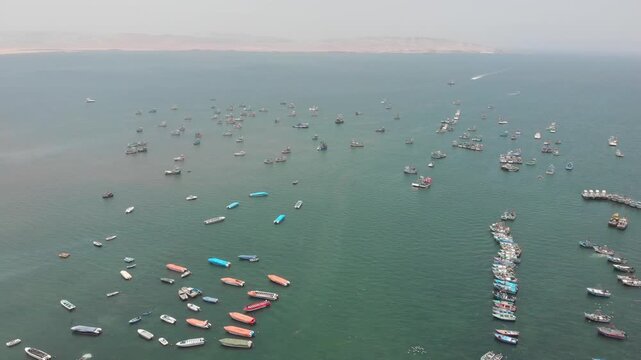 Aerial view of Paracas Bay with tourist boats and pier, Ica, Peru.