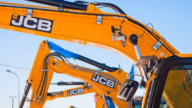 Riga, Latvia - February 8, 2026: Close-up of a JCB excavator boom against a blue sky