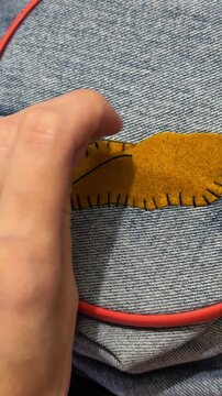 Crafting, sewing patch on clothes