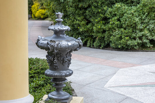 Antique cast-iron flower pots in the Arboretum park in Sochi. A monument of landscape art. Collection of subtropical flora and fauna. Park architecture and sculpture of the 19th century.