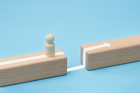 Wooden figure overcoming gap obstacle with forward direction