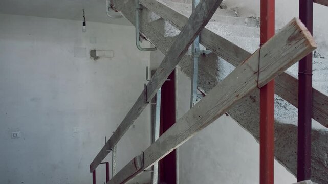 Concrete stairs and wooden railings inside a construction site