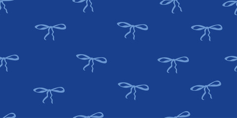 Fototapeta premium Elegant seamless pattern with small bows on blue background. Perfect for textile, packaging, wrapping paper, branding, wallpaper and feminine design projects.