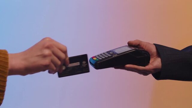 Woman Paying With Magnetic Stripe Credit Card on Payment Terminal Close Up