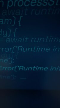 Glowing cyan programming code displays on a dark computer monitor showing software functions. Concept of modern software development, digital technology, and computer cybersecurity.