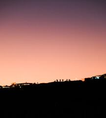 Obraz premium Human silhouettes at sunset, human figures on the hill