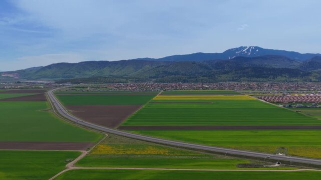 A3 Highway infrastructure and panoramic landscape with Postavaru Mountain, Dynamic Aerial Pan Right, 4K