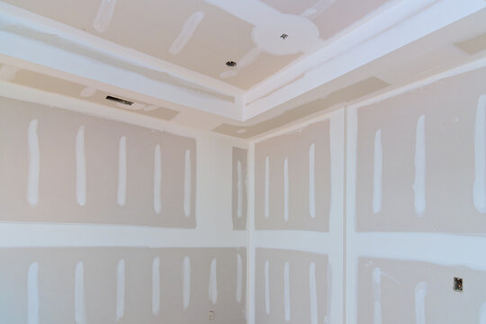 Freshly drywalled room ready for paint finishing touches in modern home renovation
