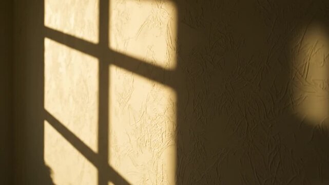 Warm Morning Sunlight and Window Frame Shadows on Textured Wall Interior Background