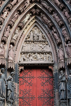  Notre Dame, gothic cathedral portal with red doors in Strasbourg
