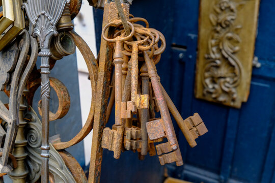 Antique keys hanging on blue door at Paris flea market