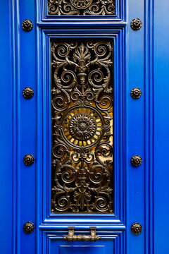 Ornate blue Paris door with gilded metalwork