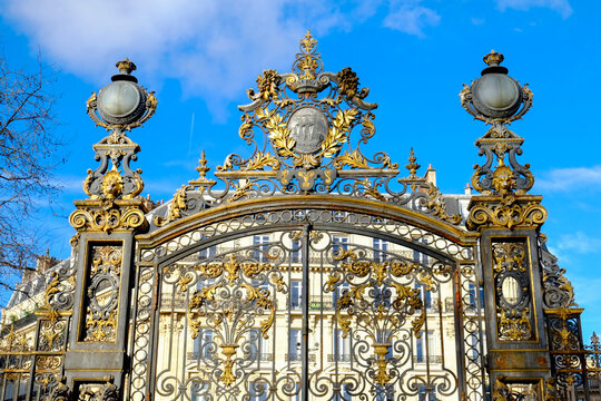 Classical sculpture and gilded gate detail in Paris