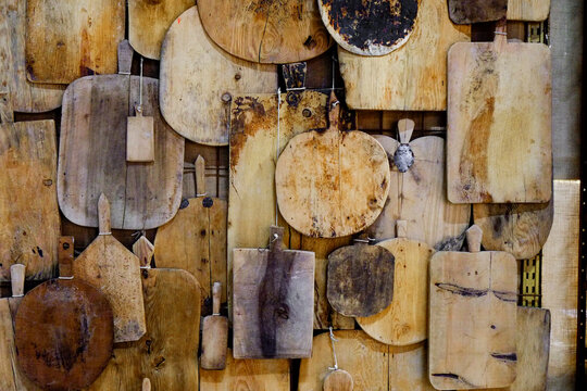 Collection of antique wooden cutting boards on wall