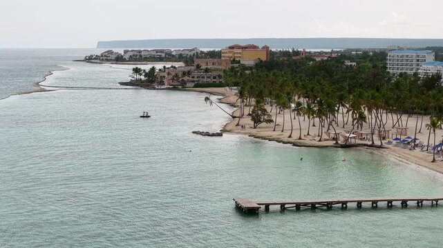 Cinematic aerial drone footage of Punta Cana, Dominican Republic featuring turquoise Caribbean waters, white sand tropical beaches, luxury resorts, palm trees, and stunning coastline views at sunrise