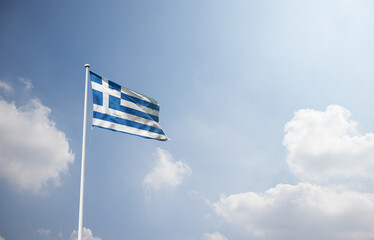 Naklejka premium Greece flag waving in sky with long mast.