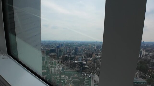 Glass windows in tall architectural building looking over a city