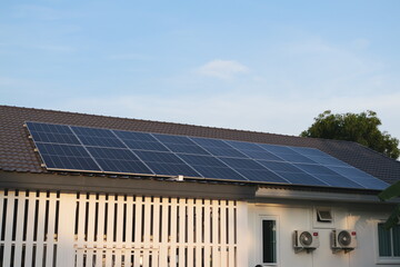 Fototapeta premium Solar energy installation residential roof urban setting photovoltaic panels clear sky