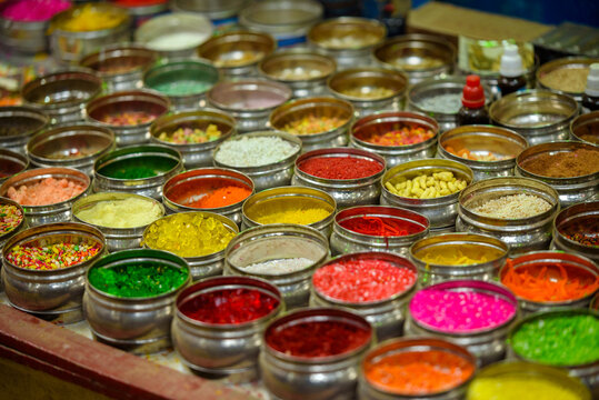 Colorful paan masala varieties displayed at a rural Bangladesh village market, showcasing traditional betel leaf preparations in vibrant packets and bowls