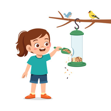 Young girl filling bird feeder with seeds and enjoying nature  