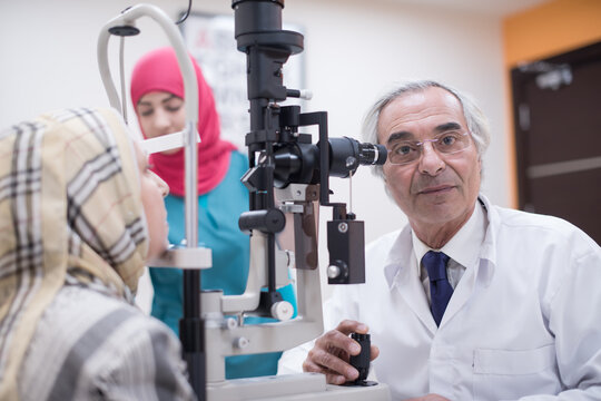 Senior ophthalmologist examining female patient with slit lamp in a Middle Eastern eye clinic in Egypt